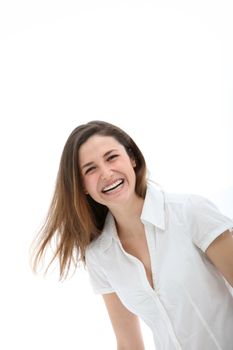 Candid image of a playful attractive young woman enjoying a good laugh while facing the camera