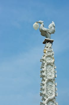 Thai style light pillar lantern with blue sky.