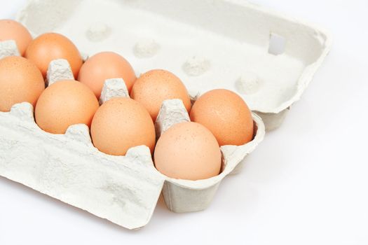 Fresh eggs in carton box on white background