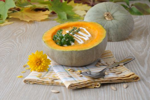 Pumpkin soup in a bowl of pumpkin and thyme and parsley