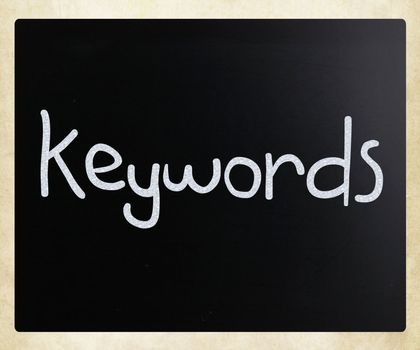 The word "Keywords" handwritten with white chalk on a blackboard