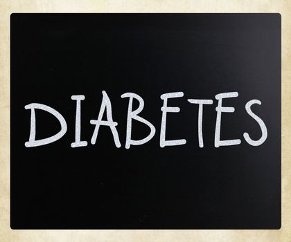 "Diabetes" handwritten with white chalk on a blackboard