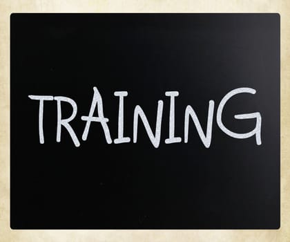 "Training" handwritten with white chalk on a blackboard