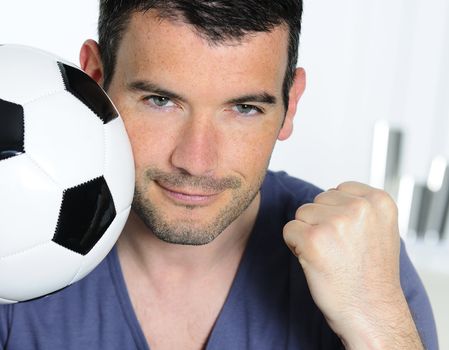 closeup of passionate soccer fan with white and black balloon