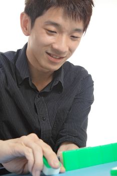 Chinese man play Mahjong, traditional China gamble. 