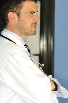 portrait of doctor in front an entrance of the hospital