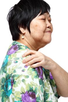 senior woman holding her aching back , massage herself