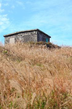 old stone house with grass on the mountain 