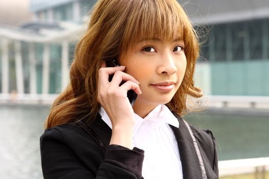beautiful business woman on the phone at modern building 