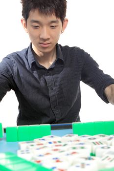 Chinese man play Mahjong, traditional China gamble. 