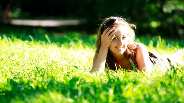 beautiful girl laying on sunny meadow