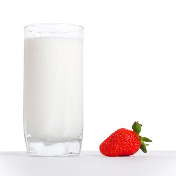 glass of milk and strawberry on table