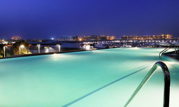 view of dubai by night by the pool 