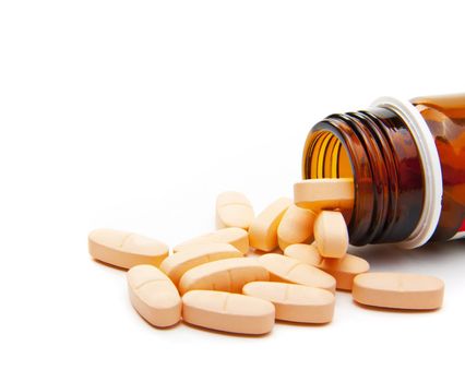 Pills from bottle on the white background