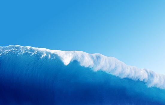 Large Blue Surfing Wave Breaks in the Ocean