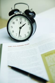 Clock on table ,Pen on open book