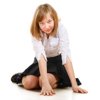 cute schoolgirl sitting on floor, isolated on white