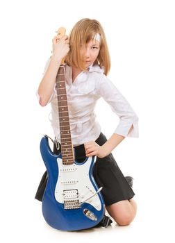 teen girl playing on a guitar, isolated on white