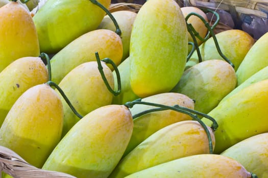 yellow mango in bamboo basket