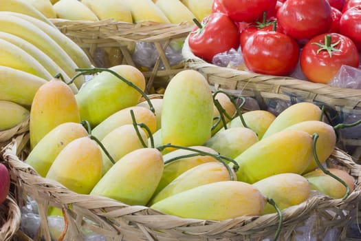 yellow mango in bamboo basket