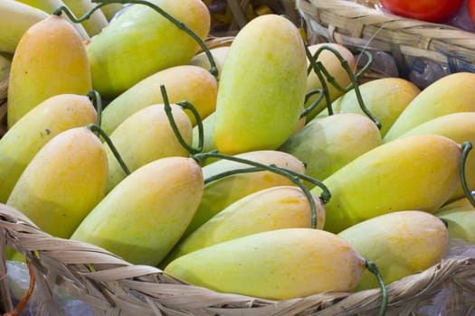 yellow mango in bamboo basket