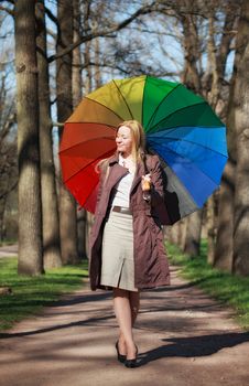 beautiful blond woman with funny umbrella in spring park