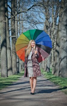 beautiful blond woman with funny umbrella in spring park