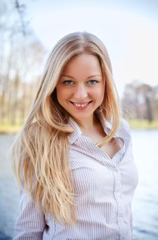 beautiful smiling blond woman in spring park