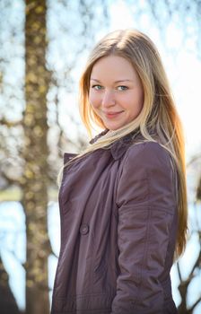 beautiful smiling blond woman in spring park