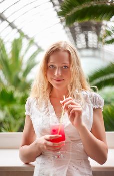 beautiful girl with cocktail glass in cafe