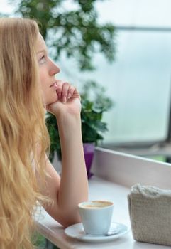 beautiful girl with coffee cup in cafe