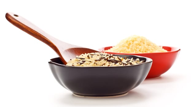 two bowls with rice and wooden spoon