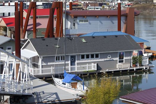 Floating homes and sailboat parked in front, Portland OR. 