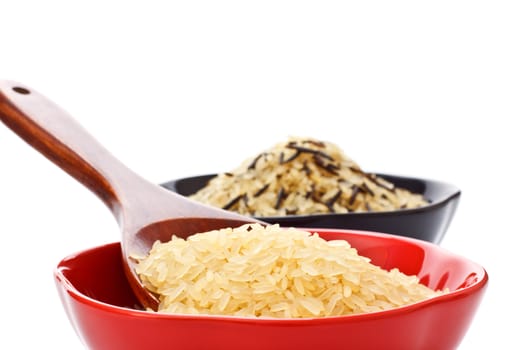 two bowls with rice and wooden spoon