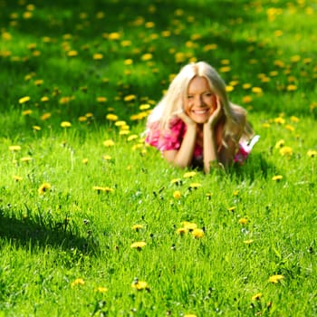  girl lying on the field of dandelions