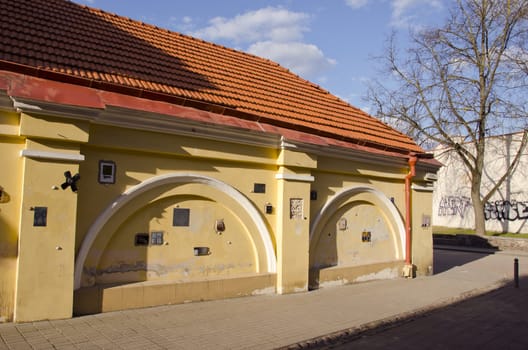 Ancient architecture of old town building yellow wall details and decorations on it.