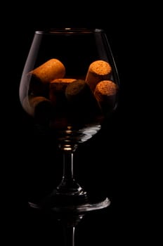 Cork in a glass on black background