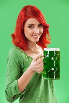 Photo of a beautiful redhead holding a huge mug of green beer for St. Patricks Day celebrations.