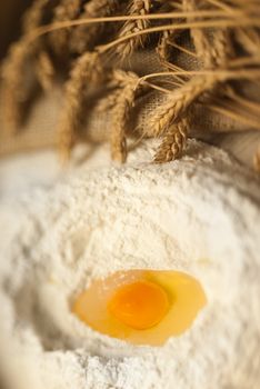 Defocused baking tray with wheat and eggs