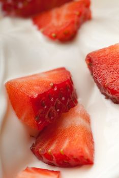 White yoghurt with large red strawberry pieces