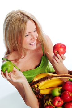 woman holds a basket of fruit on a white background