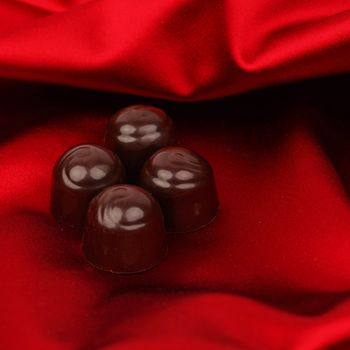 chocolate candy on red satin background