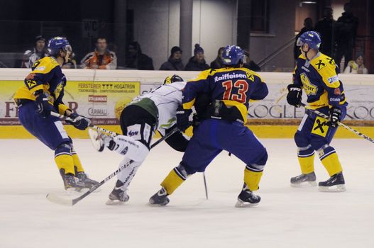 ZELL AM SEE; AUSTRIA - JAN 14: Austrian National League. D'Ambros Gunther number 13 of Zell am See (blue jersey) is stopping Tobias Holzer number 5 of EC Dornbirn. Igor Rataj number 93 and Jan Nemecek number 6 of Zell am See are in position to get not scored on. Game between EK Zell am See and EC Dornbirn (Result 3-1) on January 14, 2012.