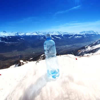 water in cup mountains on background