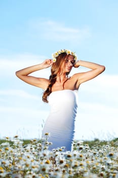 beautiful girl  in dress on the daisy flowers field 