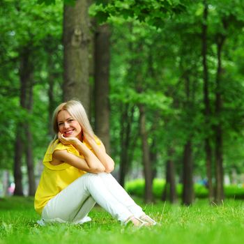 happy woman sitting on grass