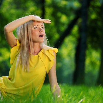 happy woman sitting on grass