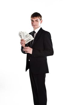 Portrait of a young businessman in a dark suit surrounded by flying dollar bills