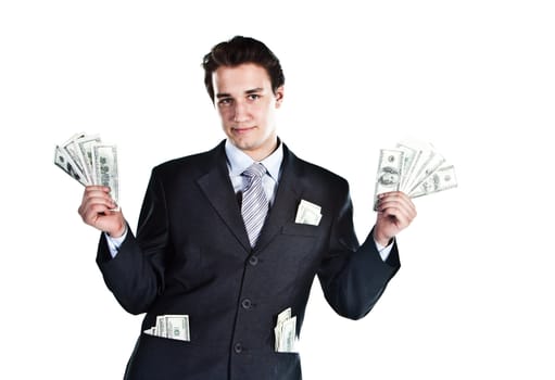 Portrait of a young businessman in a dark suit surrounded by flying dollar bills