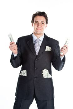 Portrait of a young businessman in a dark suit surrounded by flying dollar bills